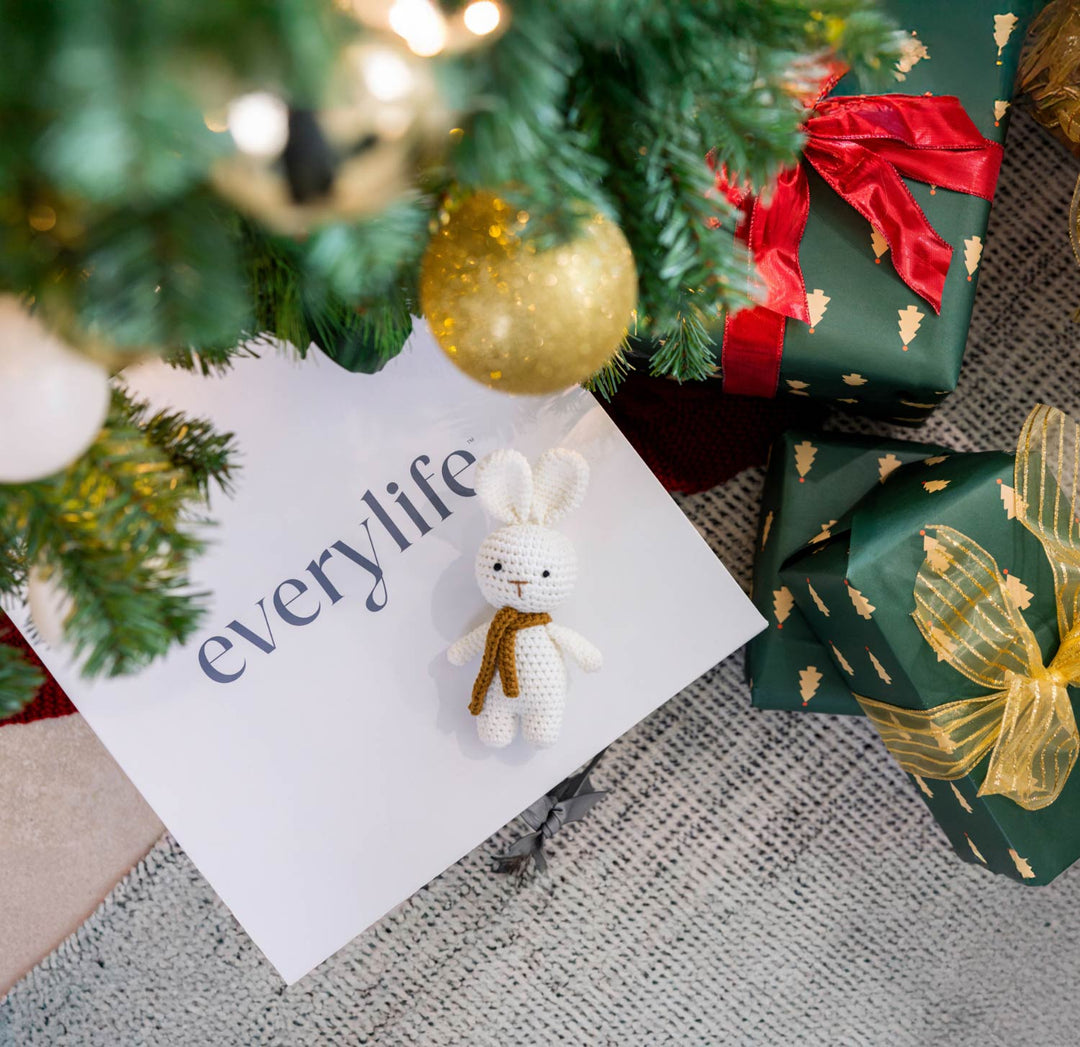 new baby gift box under a decorated Christmas tree